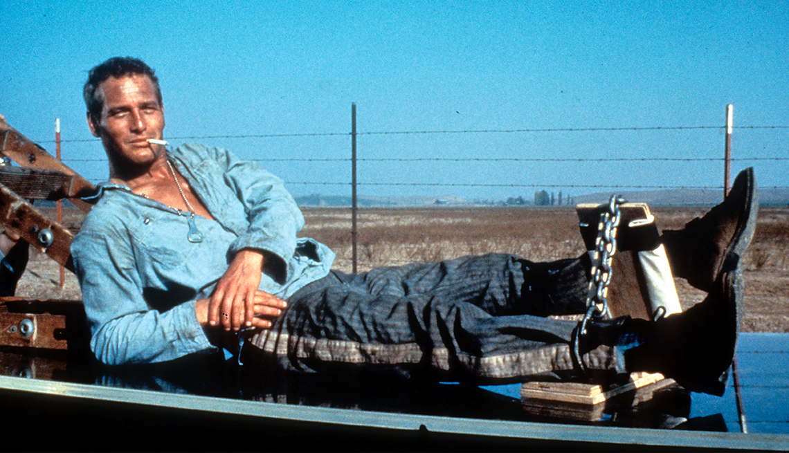 item 30 of Gallery image - Paul Newman laying down with his legs in irons in Cool Hand Luke