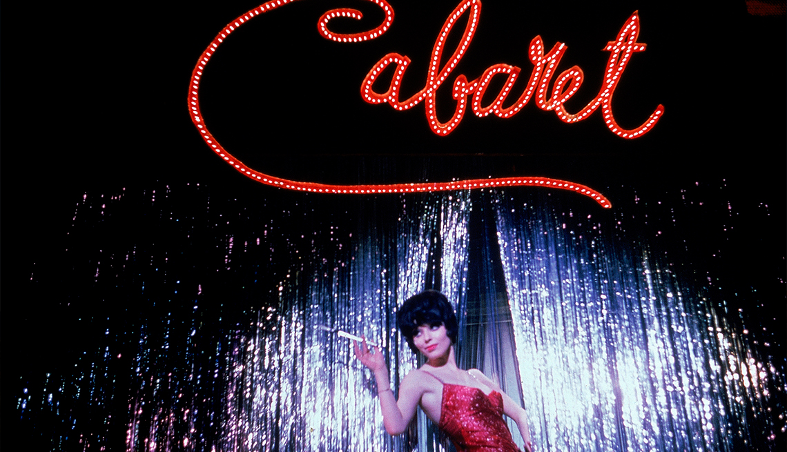 item 11 of Gallery image - 'Cabaret' sign in lights with woman in red dress onstage