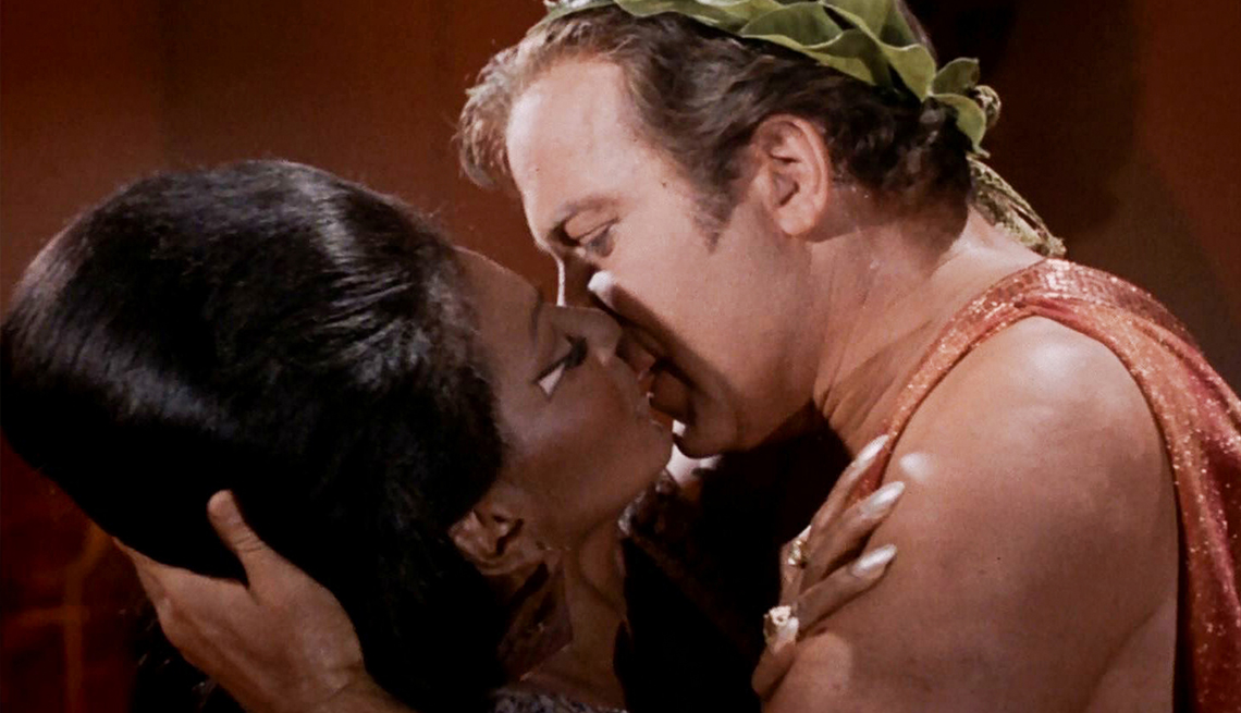 item 9 of Gallery image - Star Treks' Nichelle Nichols as Uhura and William Shatner as Captain James T. Kirk kissing during a scene