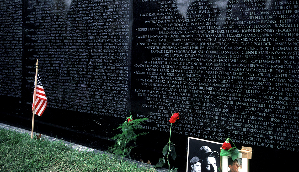 item 18 of Gallery image - Vietnam Veterans Memorial wall with photos, roses and small American flag