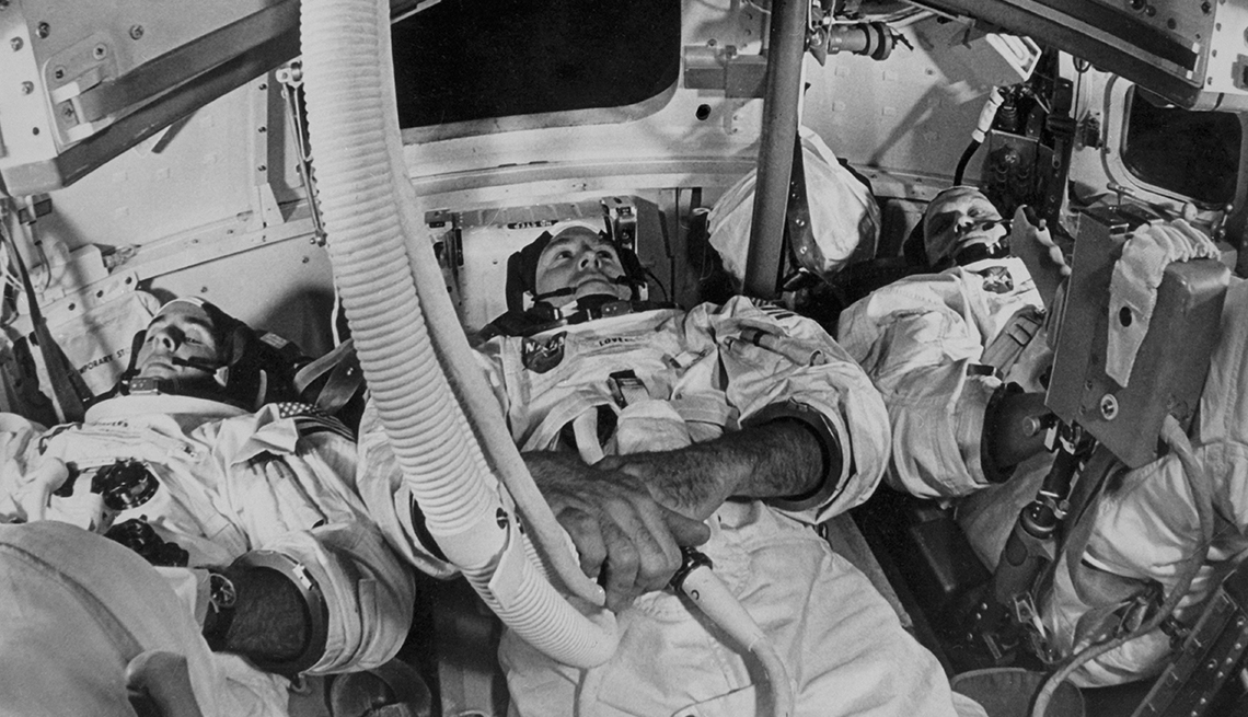 item 8 of Gallery image - Three astronauts look in different directions in the cockpit of Apollo 8