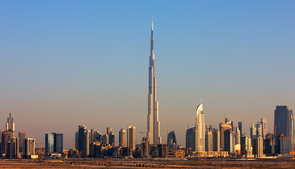 item 28 of Gallery image - a towering building soars over other, smaller buildings in Dubai
