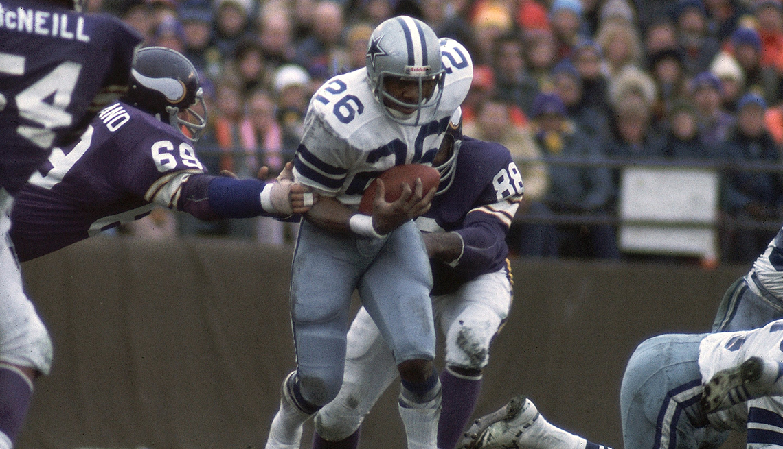 item 4 of Gallery image - A Dallas Cowboys player carries the ball while running past several Minnesota Vikings players
