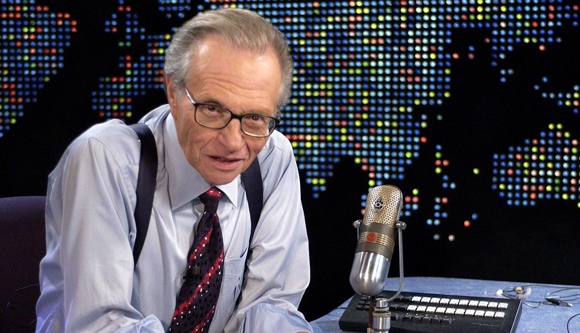 item 16 of Gallery image - Seated beside his desk and microphone, Larry King looks into the camera on the set of Larry King Live