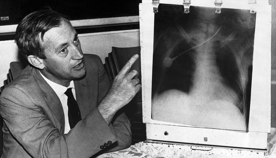 item 29 of Gallery image - surgeon Christiaan Barnard pointing to an X-ray image of Louis Washkansky's chest taken during the first heart transplant