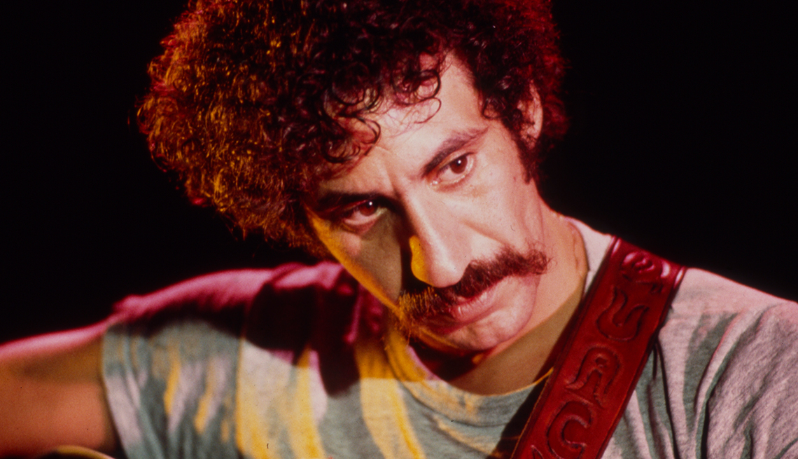 item 3 of Gallery image - Singer/songwriter Jim Croce looks to the side while playing guitar during a performance