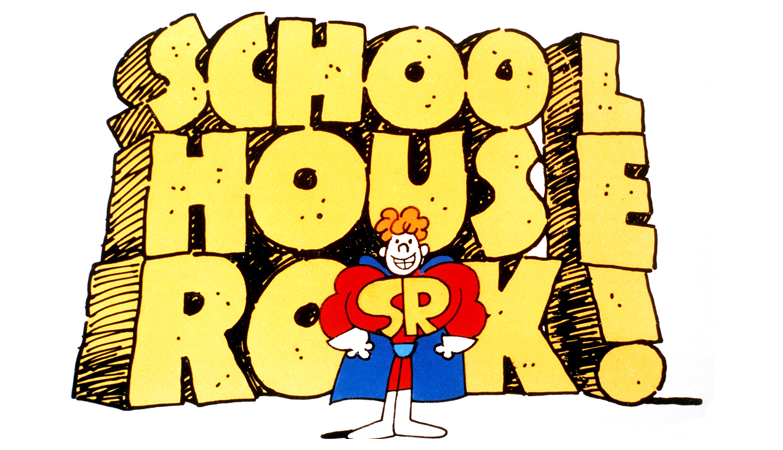item 26 of Gallery image - An illustration of a superhero dressed in a red jumpsuit with a blue cape and the letters SR on his chest in front of the words 'School House Rock!’
