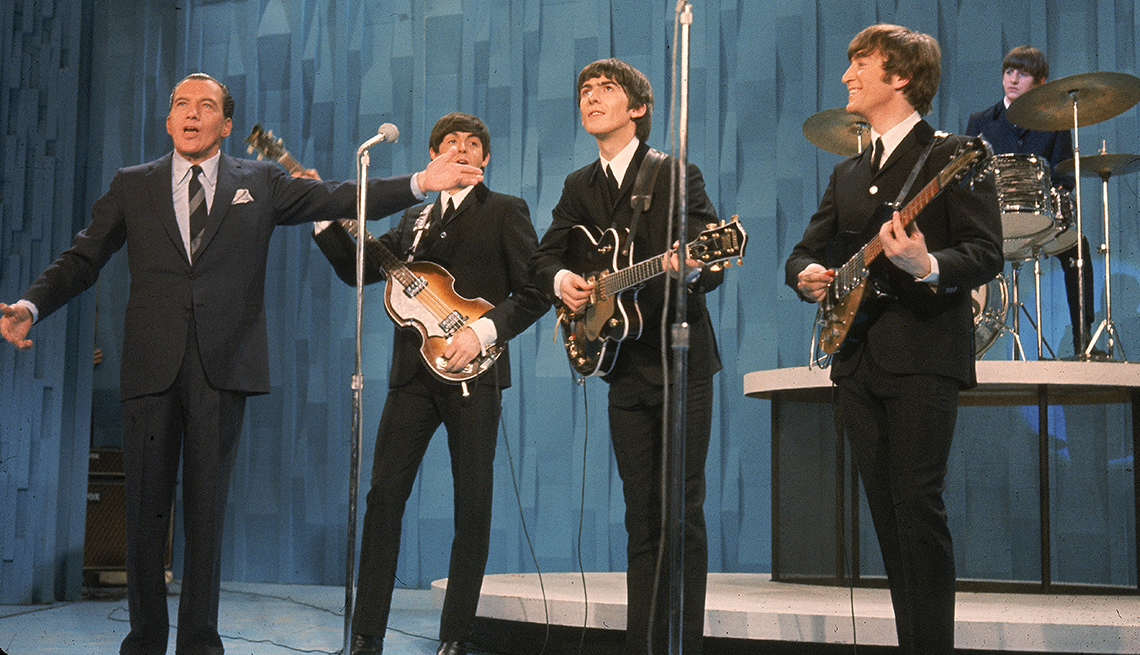 item 20 of Gallery image - Ed Sullivan gestures toward Beatles members George Harrison, Paul McCartney, John Lennon and Ringo Starr during his show