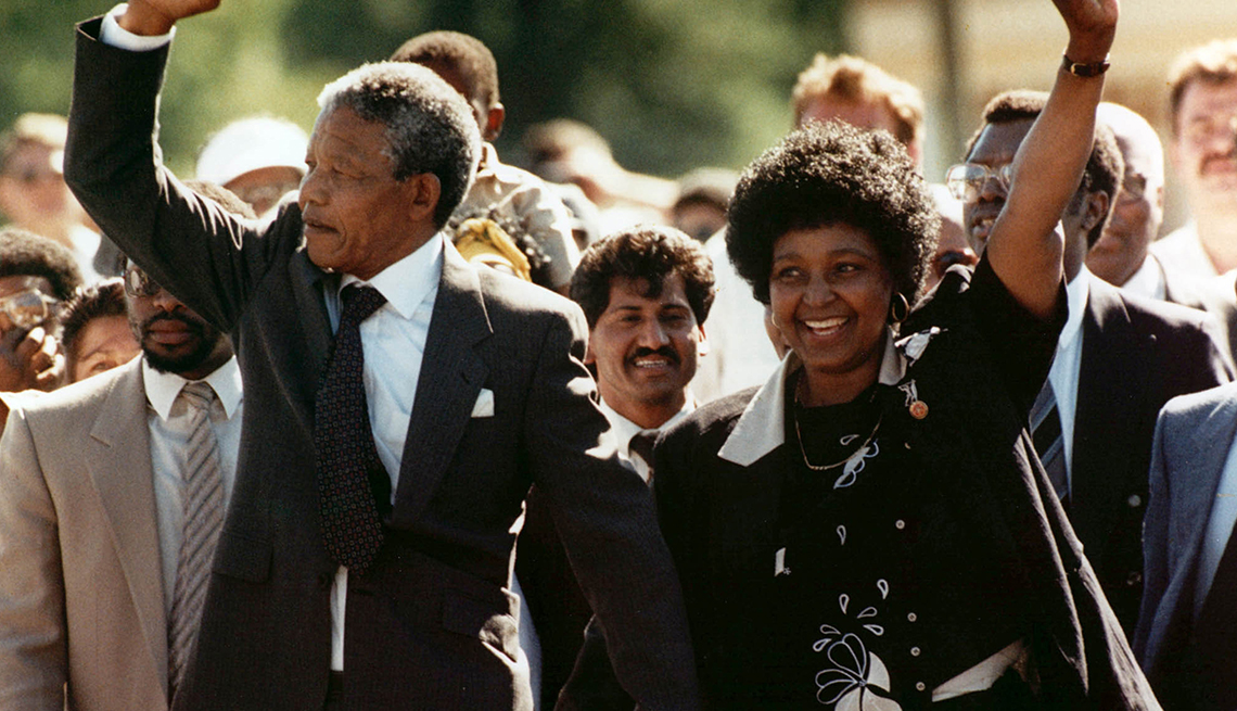 item 18 of Gallery image - Nelson Mandela and his wife, Winnie, hold up their arms in celebration in front of a crowd