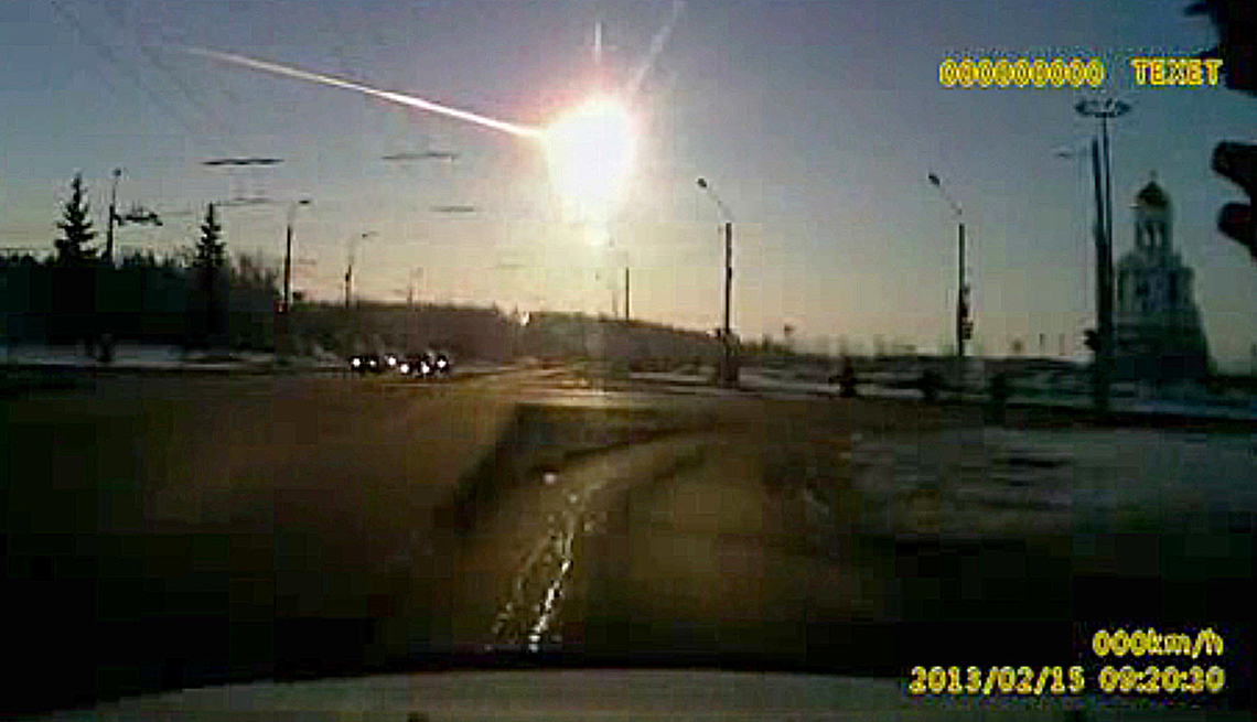 item 14 of Gallery image - a dashcam video image shows a bright light in the sky above a roadway