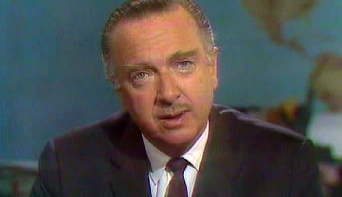 item 2 of Gallery image - Walter Cronkite looks at the camera while delivering a commentary on the set of the CBS Evening News
