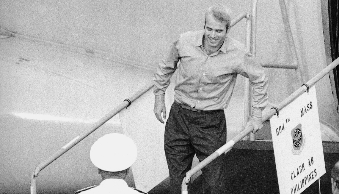 item 18 of Gallery image - a black and white picture showing a young john mccain walking down steps from an airplane