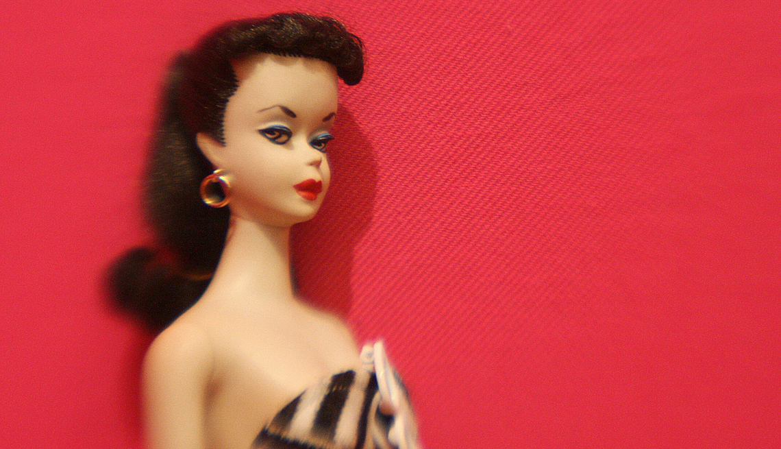 item 23 of Gallery image - an old time barbie doll with brown hair and earrings on a red background