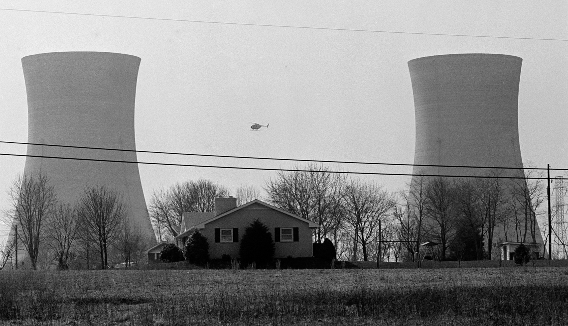 item 4 of Gallery image - A helicopter flies between two huge cooling towers at the Three Mile Island Nuclear Generation Plant in Harrisburg, Penn., March 30, 1979