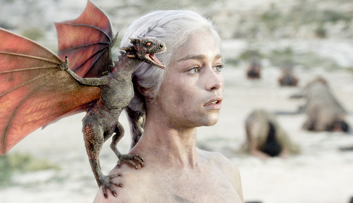 item 14 of Gallery image - Emilia Clarke plays Daenerys Targaryen in the “Game of Thrones’ TV show. A small dragon sits on her shoulder.