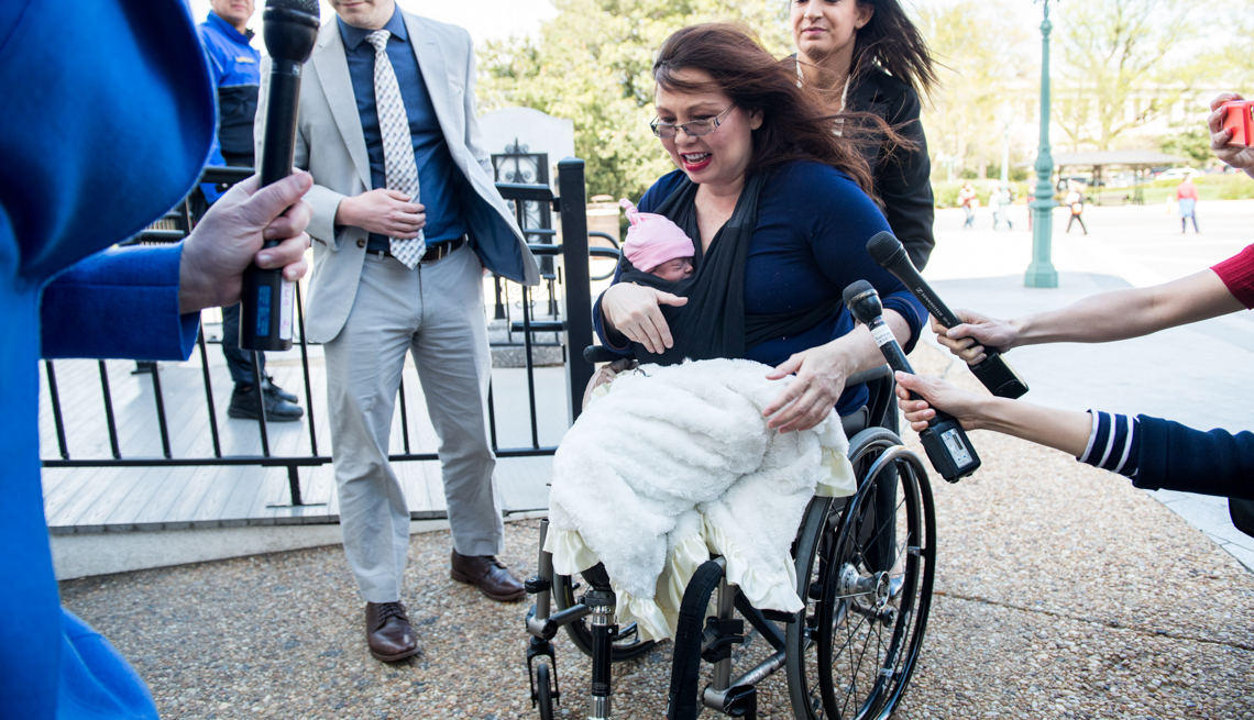 item 12 of Gallery image - Sen. Tammy Duckworth, D-Ill., arrives with her newborn baby Maile to cast a vote on the Senate floor on Thursday, April 19, 2018.