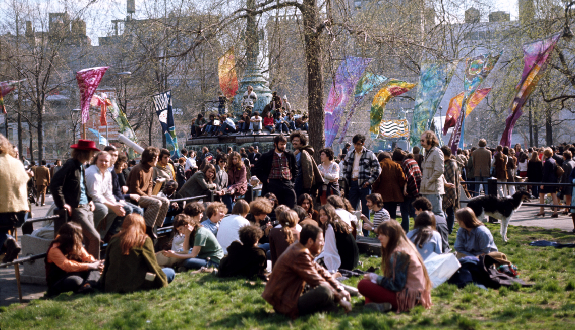 item 9 of Gallery image - A crowd sits in a park on Earth Day on April 20, 1970 in New York, New York. 
