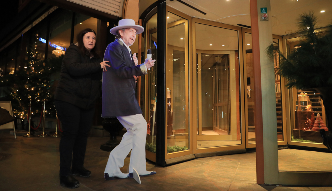 item 30 of Gallery image - A woman brings a life-size photo panel of American singer song writer Bob Dylan to the hotel, where Nobel Prize laureates are supposed to stay in Stockholm, Sweden on Dec. 8, 2016. 