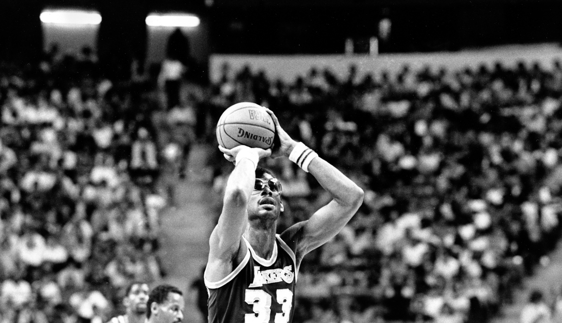 item 26 of Gallery image - Los Angeles Lakers center Kareem Abdul-Jabbar (33) shoots one of his baskets on his way to breaking Wilt Chamberlain's NBA scoring record during action against the Utah Jazz in Las Vegas, Nev., Thursday, April 5, 1984. 