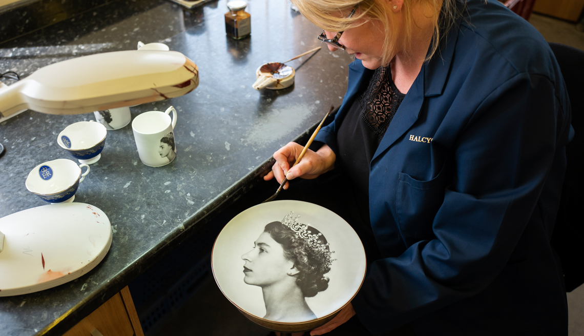 Jane Oakley hand paints a Jubilee themed plate on May 17, 2022 in Stoke on Trent, England.