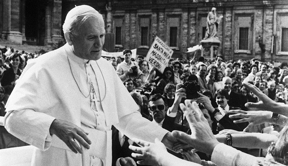 Pope John Paul II (C) blesses followers a few seconds before being shot and seriously wounded 13 May 1981 at Saint Peter's square by a Turkish extremist Mehmet Ali Agca.