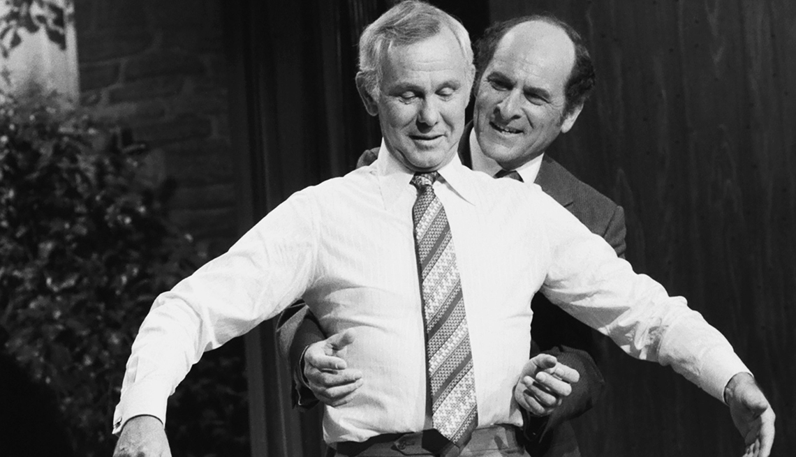 item 26 of Gallery image - Pictured: Dr. Henry Heimlich demonstrates the heimlich maneuver on host Johnny Carson on April 4, 1979 