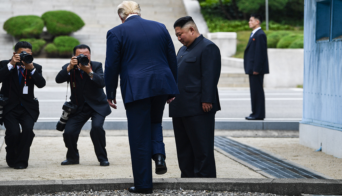 item 1 of Gallery image - US President Donald Trump steps into the northern side of the Military Demarcation Line that divides North and South Korea, as North Korea's leader Kim Jong Un looks on