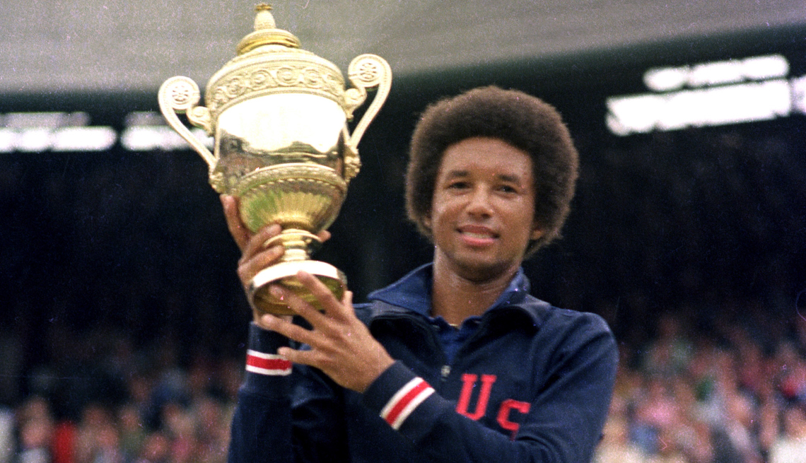 item 3 of Gallery image - Arthur Ashe holds his Wimbledon trophy