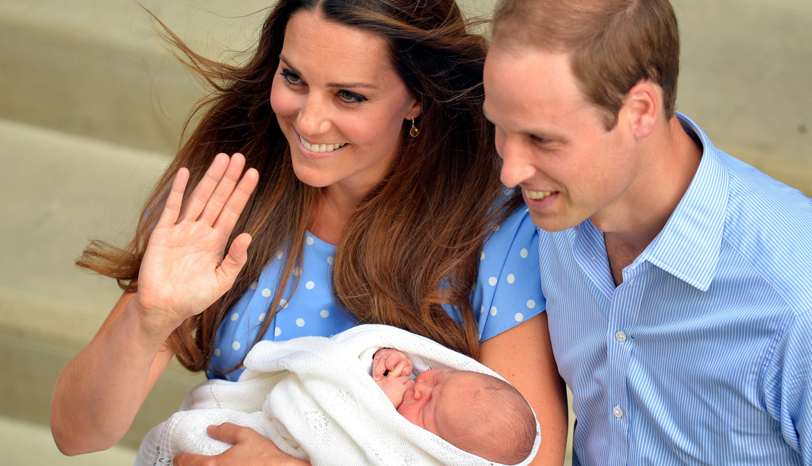 item 10 of Gallery image - Kate Middleton holds her new baby, George, as her husband Prince William stands near 