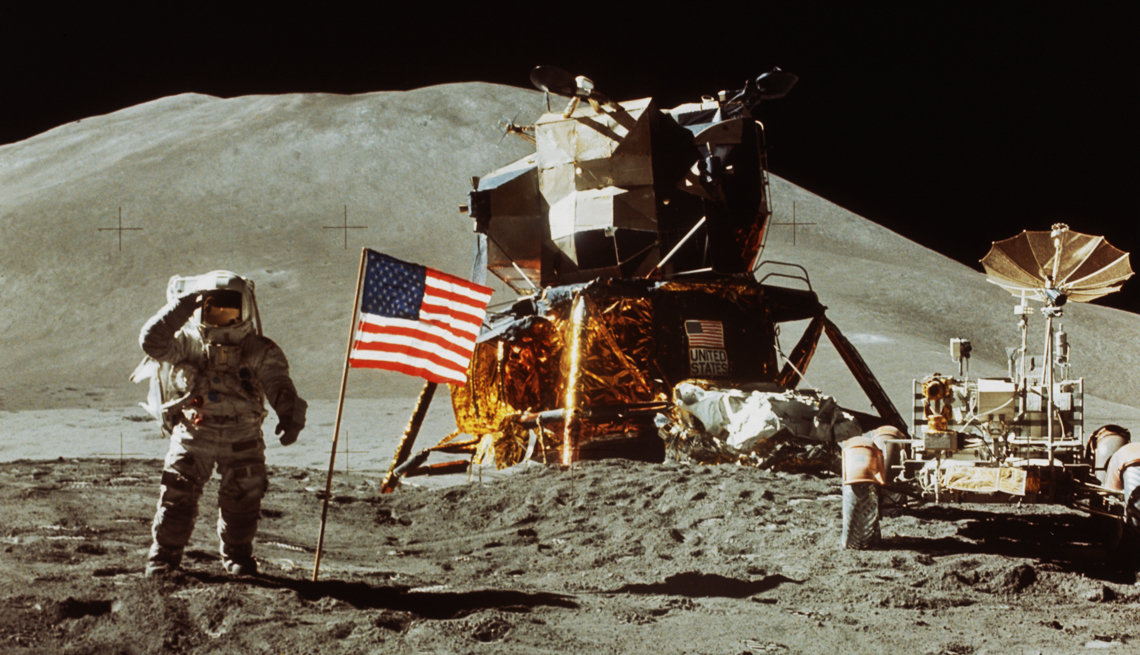 item 1 of Gallery image - Astronaut James Irwin salutes the American Flag near a rover and lunar module on the moon