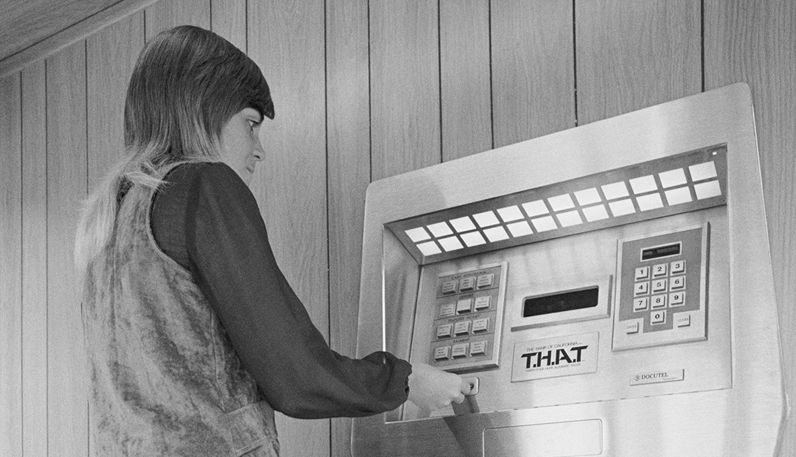 item 29 of Gallery image - Jaynee Hurd demonstrates the first automated teller machine at the Los Angeles branch of the Bank of California.