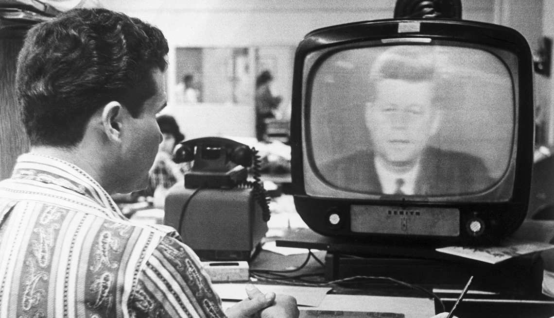 item 10 of Gallery image - man sitting and watching president john F kennedy on television