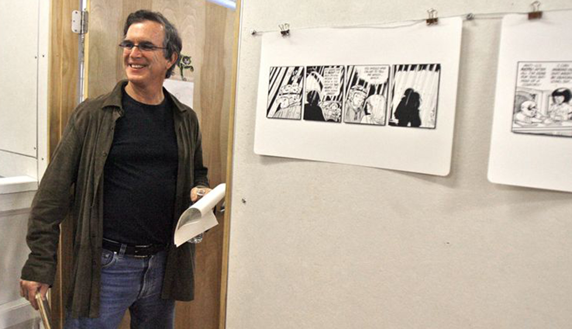 item 6 of Gallery image - garry trudeau smiling inside a classroom with comics hanging on the wall