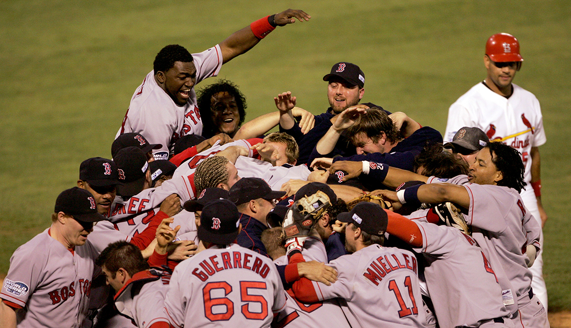 item 5 of Gallery image - boston red sox baseball players celebrate on field; behind them is a saint louis cardinal player who looks disappointed
