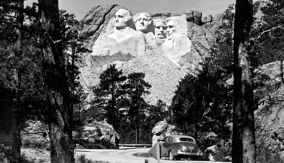 item 1 of Gallery image - mount rushmore; george washington, thomas jefferson, abraham lincoln and theodore roosevelt carved into mountainside; trees on ground below on both sides