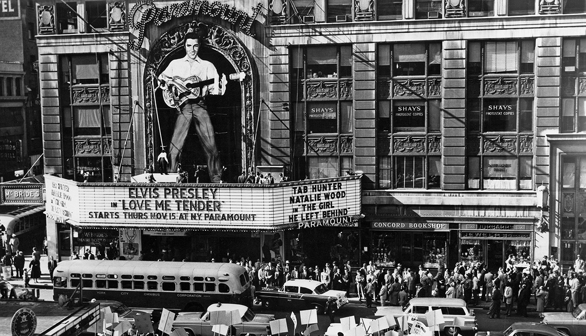 item 16 of Gallery image - giant cut out of elvis presley over theater sign reading elvis presley love me tender; crowds waiting outside theater