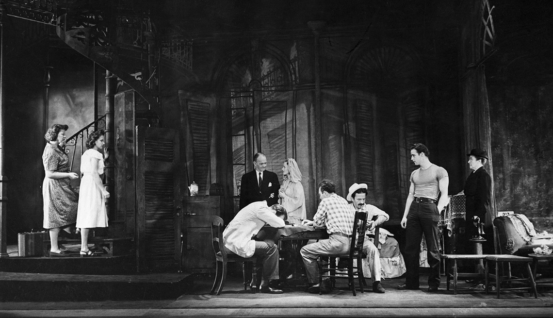 item 2 of Gallery image - actors on stage, some sitting, some standing, performing a scene from a streetcar named desire