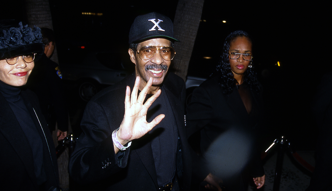item 22 of Gallery image - richard pryor in between two women as he waves to someone in front of him