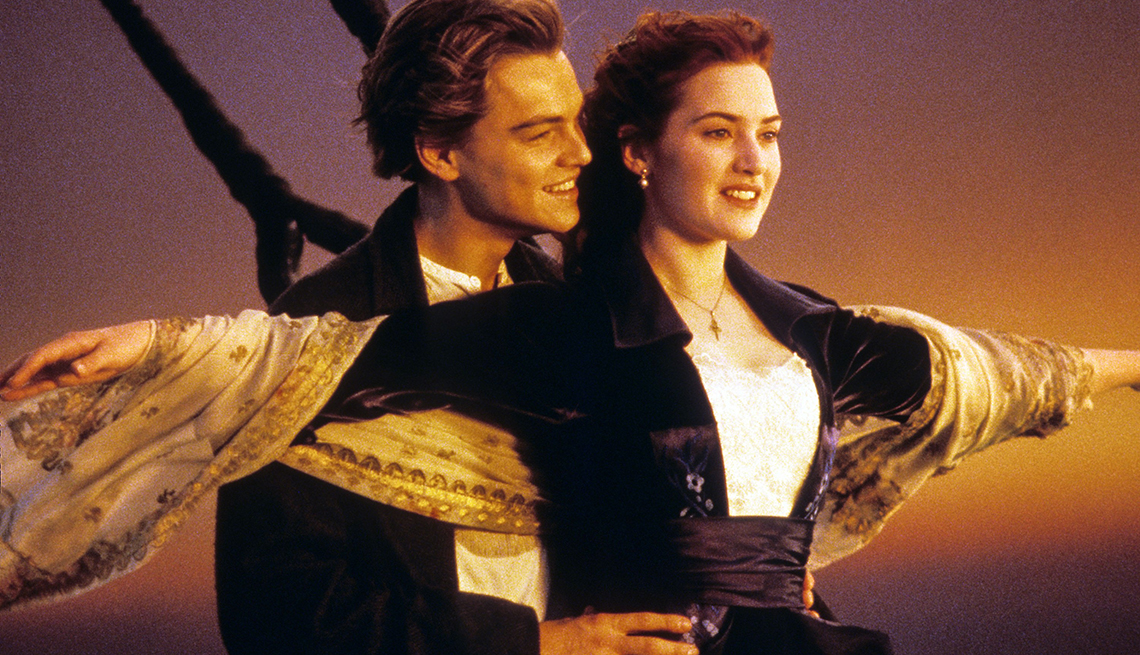 item 13 of Gallery image - leonardo dicaprio holding kate winslet's waist from beihind, while winslet puts arms out to the side in a still from titanic