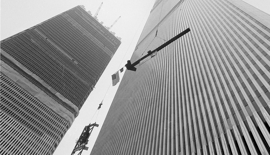 item 9 of Gallery image - american flag attached to steel column being hoisted to the top of the north tower building of the world trade center