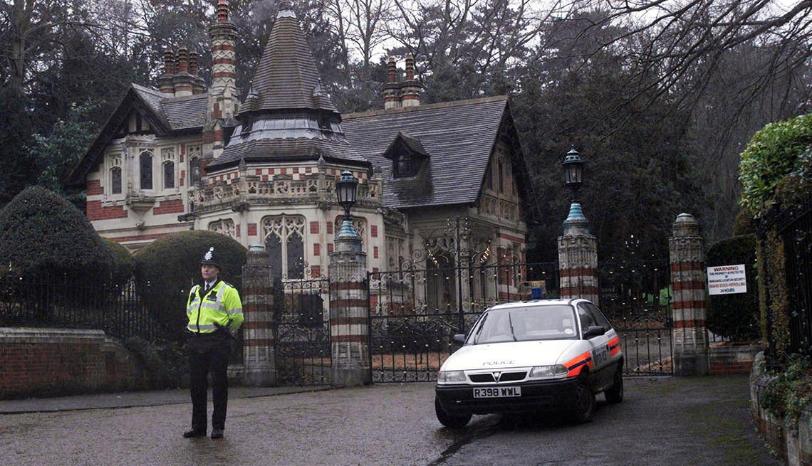item 2 of Gallery image - police officer standing outside gates of a house