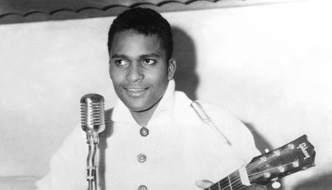 item 25 of Gallery image - charley pride holding guitar with microphone in front of him