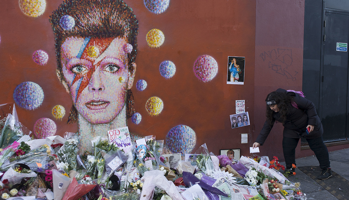 item 22 of Gallery image - makeshift shrine to david bowie of flowers, cards, pictures and other tributes