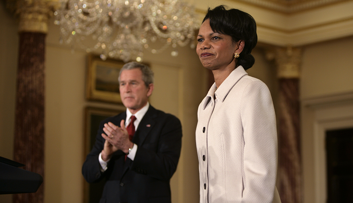 item 6 of Gallery image - president george w bush clapping, standing next to secretary of state condoleezza rice
