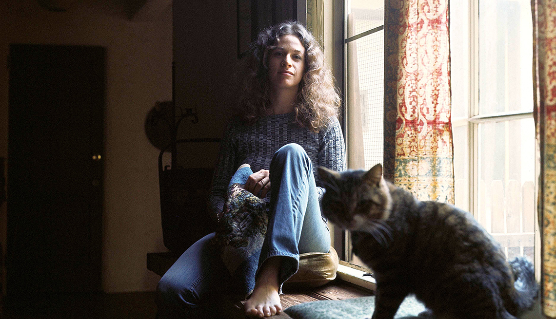 item 19 of Gallery image - Carole king sitting next to window with cat next to her
