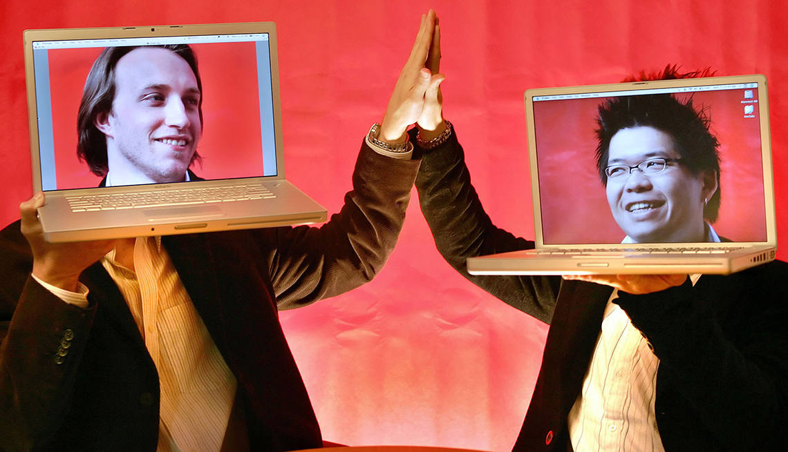 item 15 of Gallery image - chad hurley and steven chen high fiving each other while holding computers with their faces in them