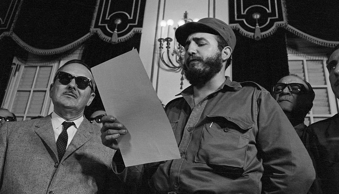 item 13 of Gallery image - fidel castro reading piece of paper; to the left is acting president manuel urrutia and at right is outgoing prime minister jose miro cardona