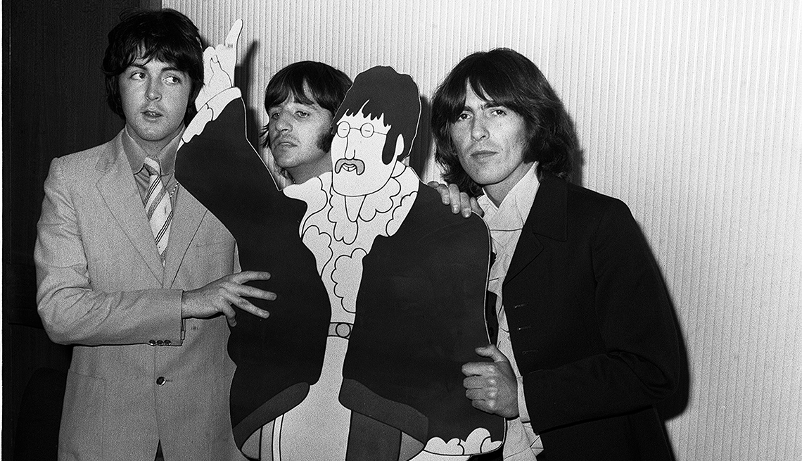 item 15 of Gallery image - The Beatles Paul McCartney, Ringo Starr and George Harrison with a cardboard cut out of John Lennon from the film Yellow Submarine