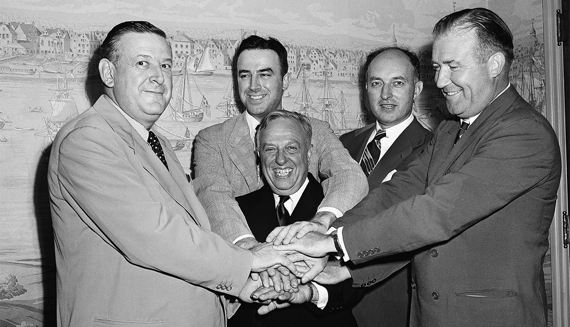 item 29 of Gallery image - Representatives of the National Basketball League and Basketball Association of America, shake hands after agreeing to a merger of the two circuits into an 18-team organization to be known as the National Basketball Association