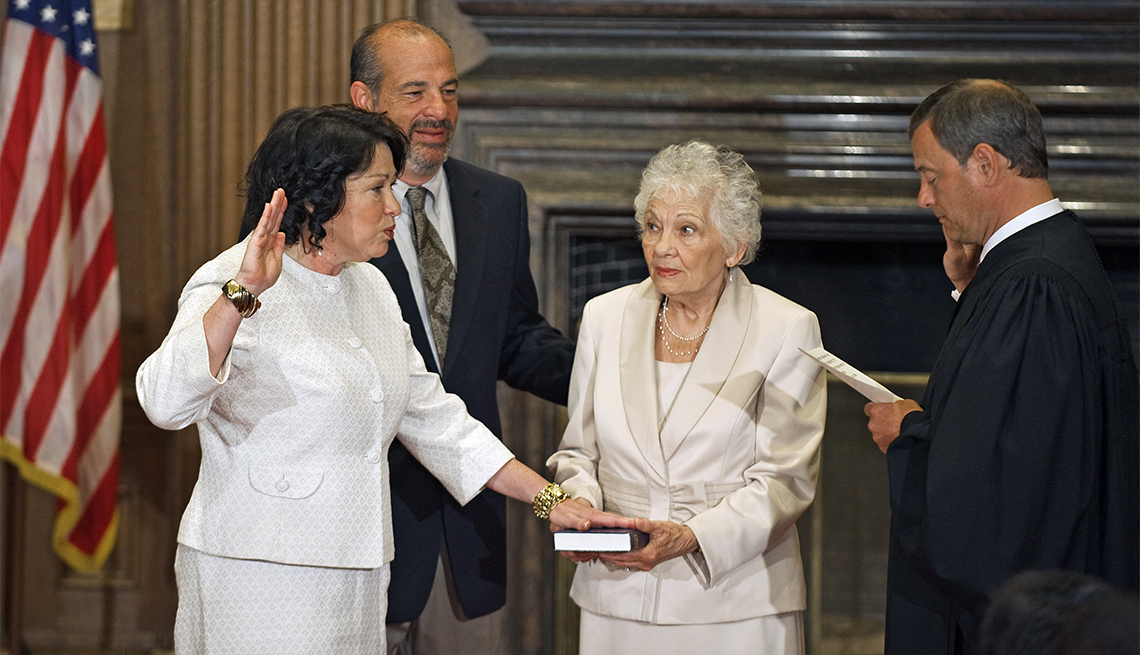 item 26 of Gallery image - Judge Sonia Sotomayor, the first Hispanic justice on the us Supreme Court, is sworn in with the Judicial Oath in the East Conference room of the Supreme Court, as the 111th Justice of the US Supreme Court by Chief Justice John Roberts as her mother Celina holds the Bible and her brother Juan Luis looks on